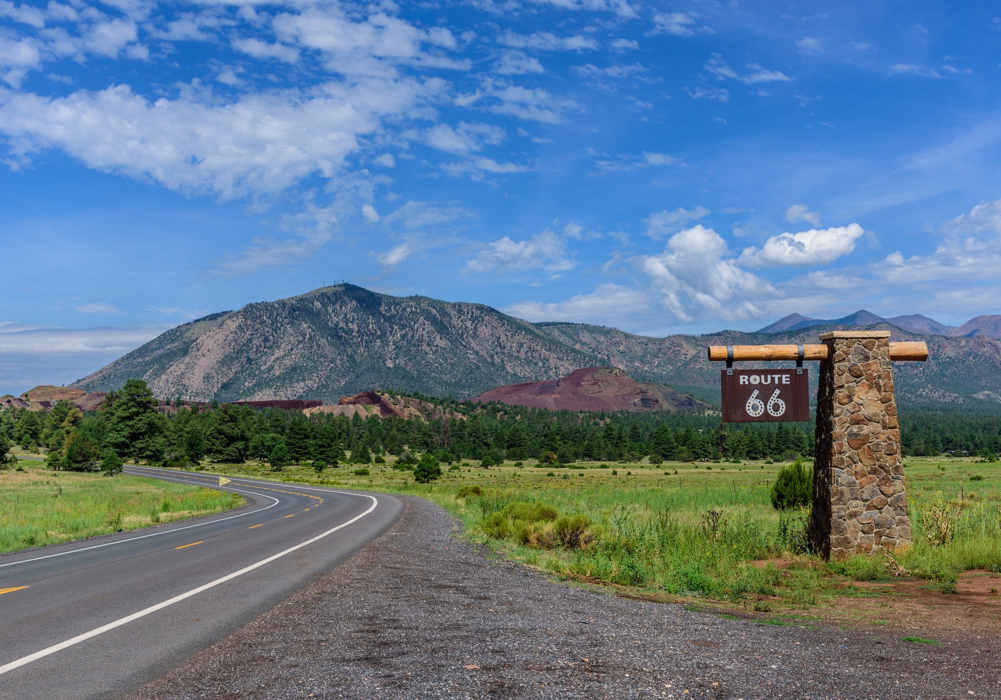 Route 66, often called the "Mother Road," holds significant historical importance as one of the original highways in the United States Highway System. It was established on November 11, 1926, and originally ran 2,448 miles from Chicago, Illinois, to Santa Monica, California.  Route 66 soon became a critical artery for economic development in the small towns that it passed through. The highway brought travelers, tourists, and commerce to these towns, contributing to their growth and prosperity.  Route 66 became an iconic symbol of American culture, representing freedom, adventure, and the open road. This cultural legacy is evident in the music, literature, and media that celebrate the highway.  One small community Winona, west of Winslow, was one of several Arizona towns mentioned in the song “Route 66,” written by Bobby Troup in 1946.  In Winona there lies an abandoned section of Route 66 containing a bridge that crosses a mostly dry wash.  This picture was photographed from an active section of Route 66 east of Flagstaff, Arizona.  Mount Elden is in the background.