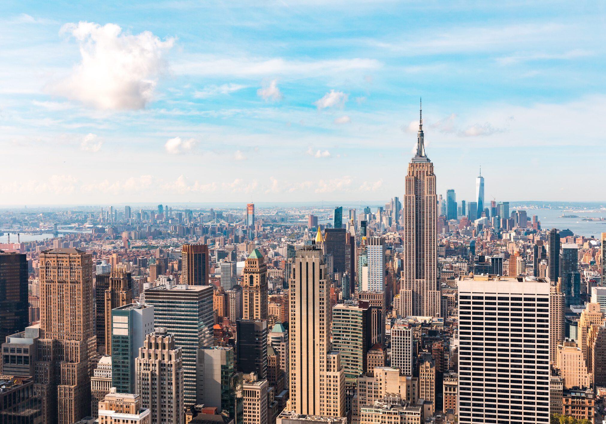 Iconic buildings overlooking bustling new york city with impressive architecture and vibrant energy in warm sunlight