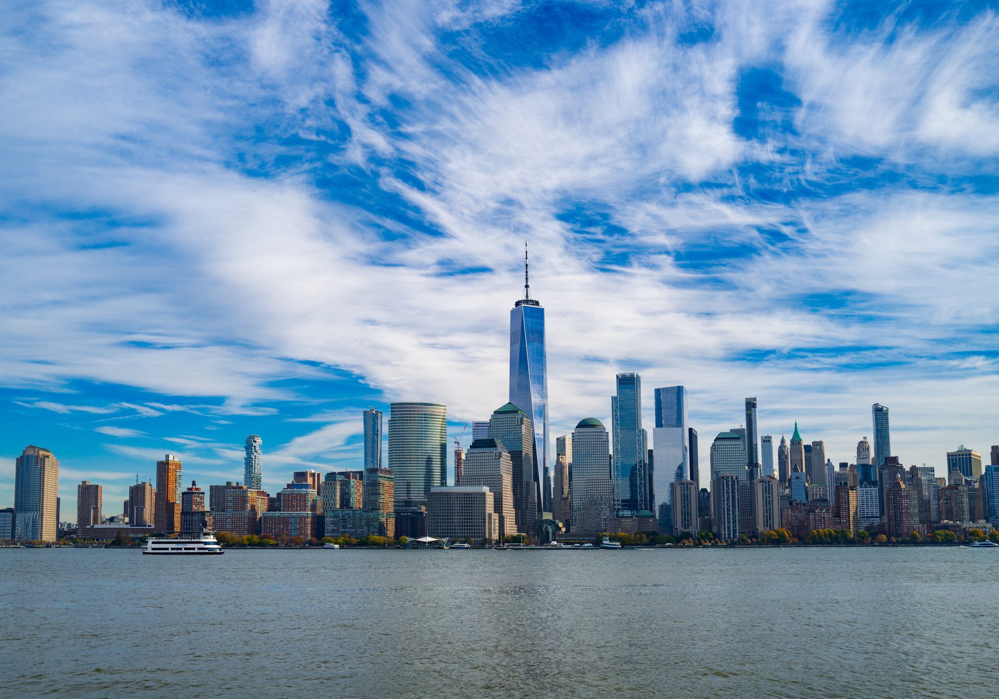 New York City skyline. NYC skyscrapers. Manhattan skyline. NY cityscape with clouds. Downtown New York buildings. NYC skyline, sky clouds. New York harbor view. Skyscrapers in Manhattan. NYC downtown